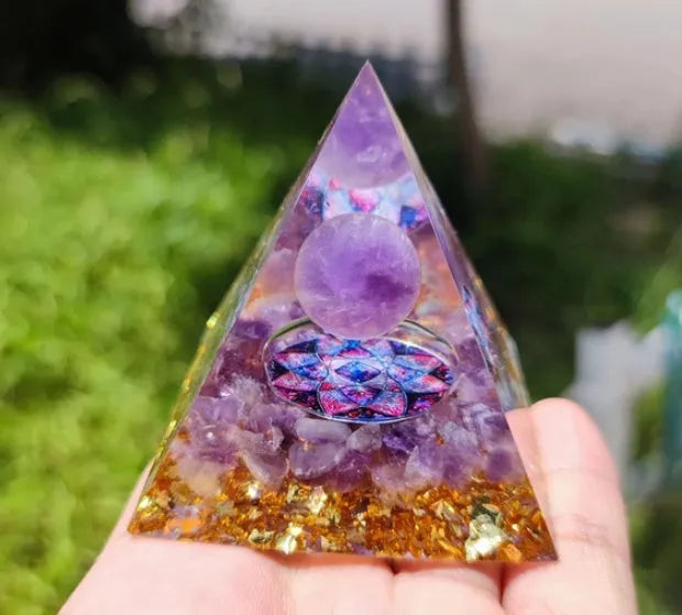 Clear epoxy resin pyramid ornament with embedded coloured crystal gravel inside, measuring 6cm.