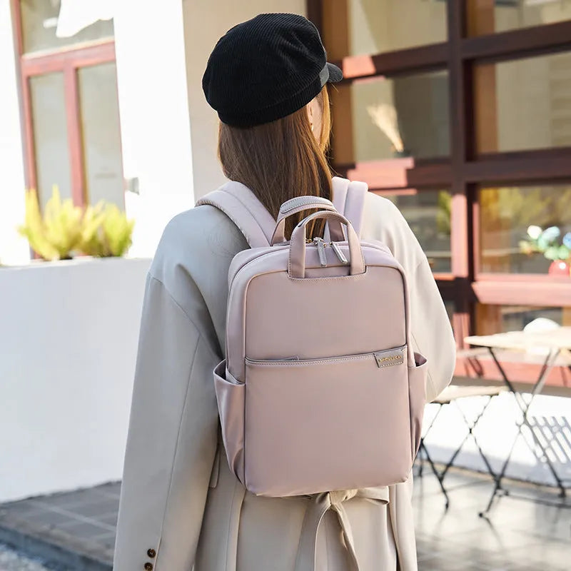 Large canvas travel backpack for women in apricot colour, showing front sandwich pocket and urban style.