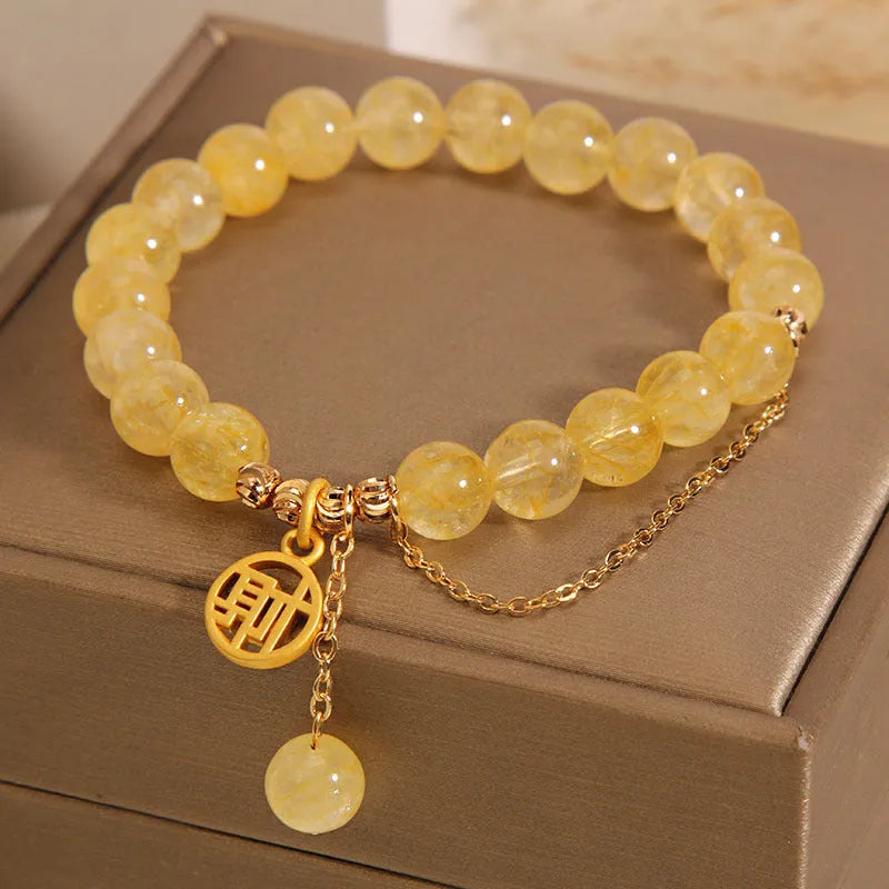 Natural citrine bracelet with gold electroplated Chinese character charm on adjustable tassel