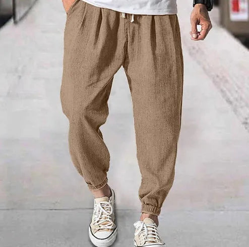 Men's casual cotton trousers with banded ankles in light green colour showing loose fit summer style
