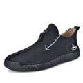 Men's black front-zip casual boots with round toe and low heel, showing the side zipper and rubber sole.