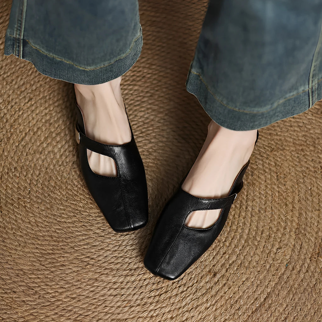 Pair of square-toe casual slippers with a low heel on a rubber sole, shown in a solid colour.