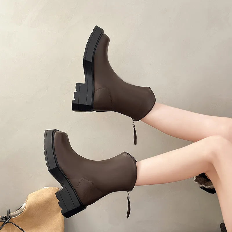 Black women's platform Martin ankle boots with a square toe, high heel, and back zipper on a white background.