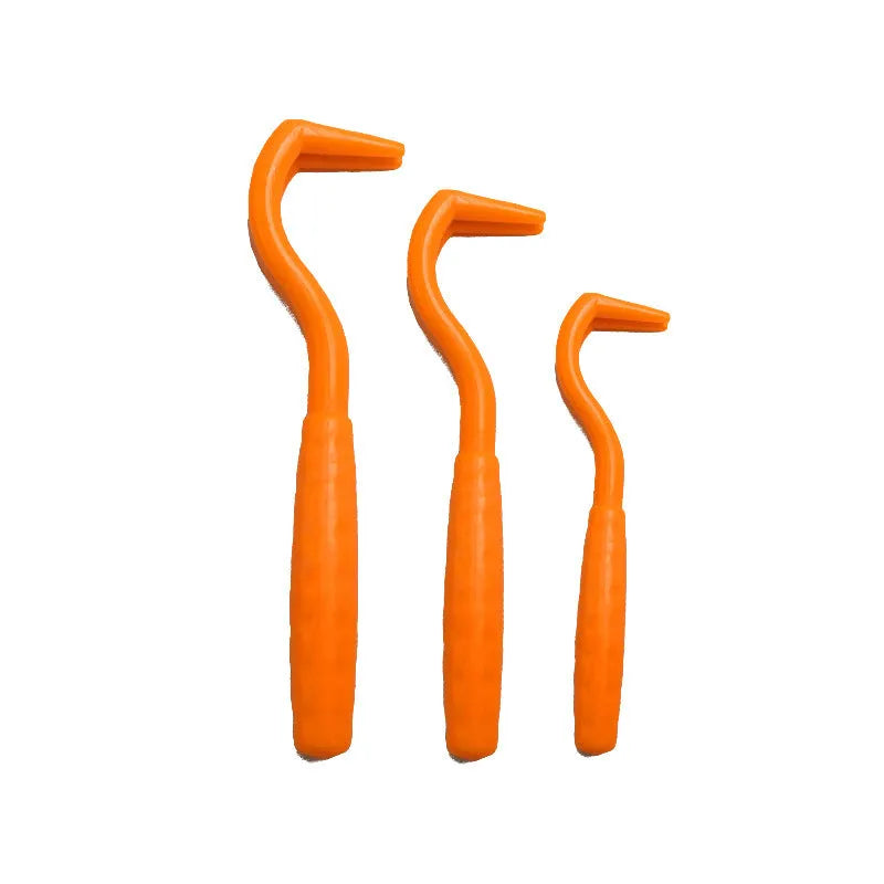 Three plastic tick removal hooks for dogs, shown in assorted colours on a white background.