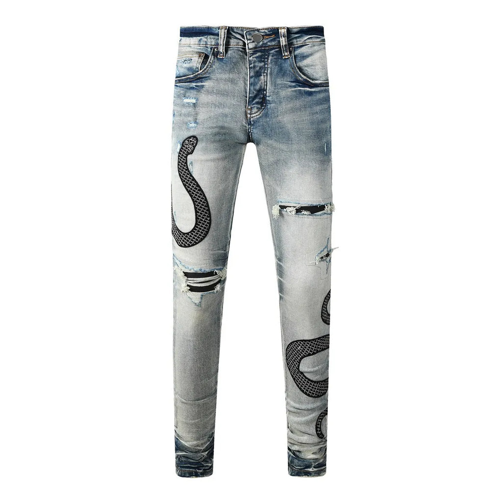 Blue distressed skinny jeans with button fly and tapered leg in street fashion style