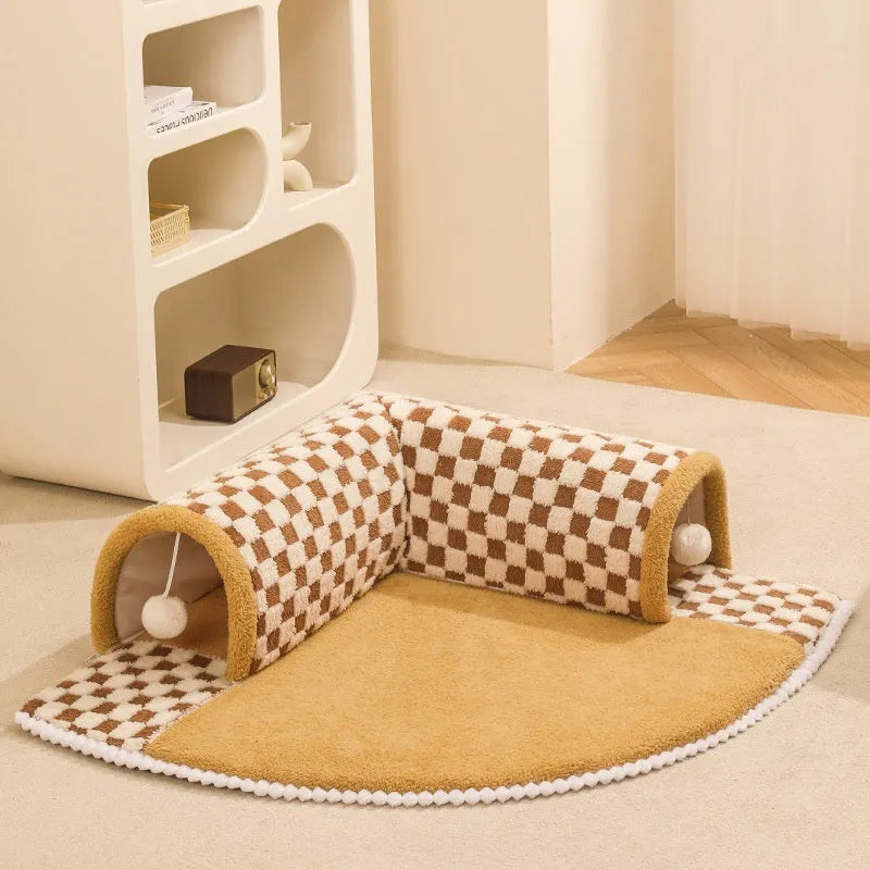 XL soft brown plaid cat tunnel bed with central mat and non-slip bottom on a wooden floor.