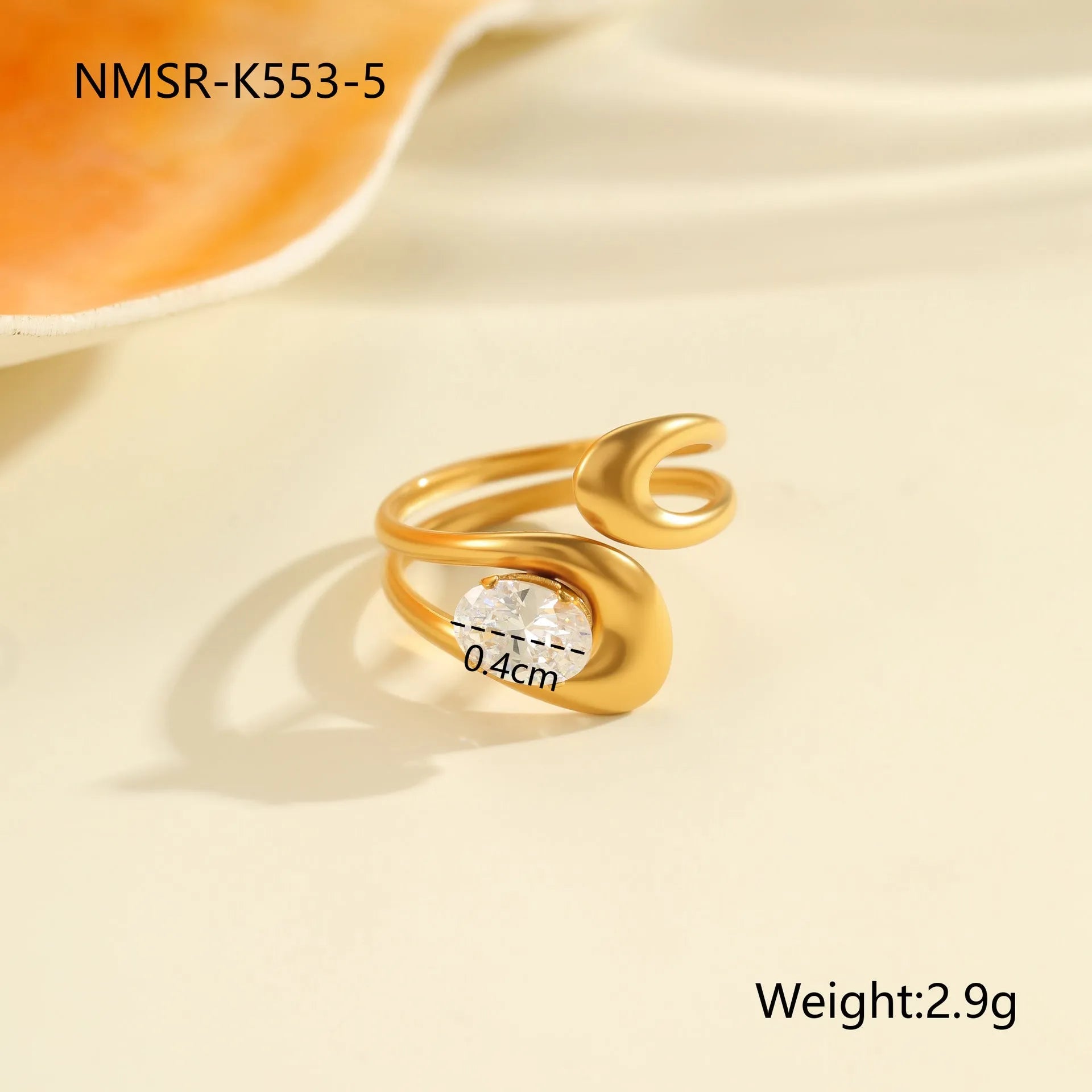 Geometric stainless steel zircon ring with open mouth design on a hand.