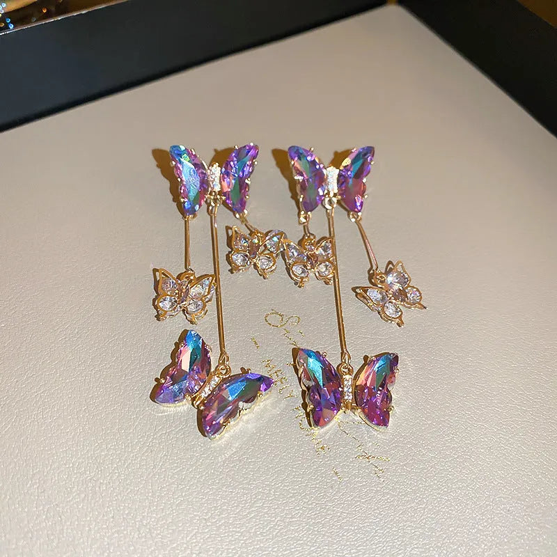 Silver electroplated butterfly tassel earrings with blue-purple crystal flowers on alloy base