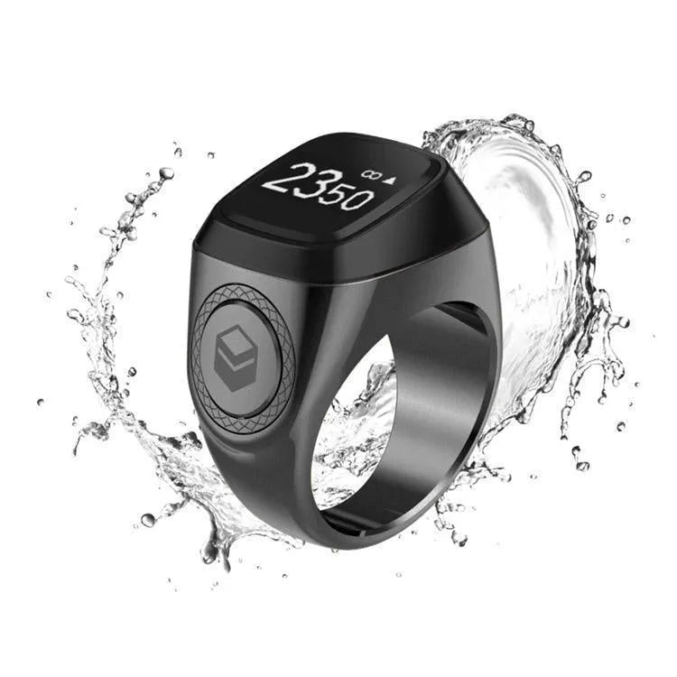 Zikr1 smart Islamic prayer ring in silver on a hand, showing its OLED display and single button.