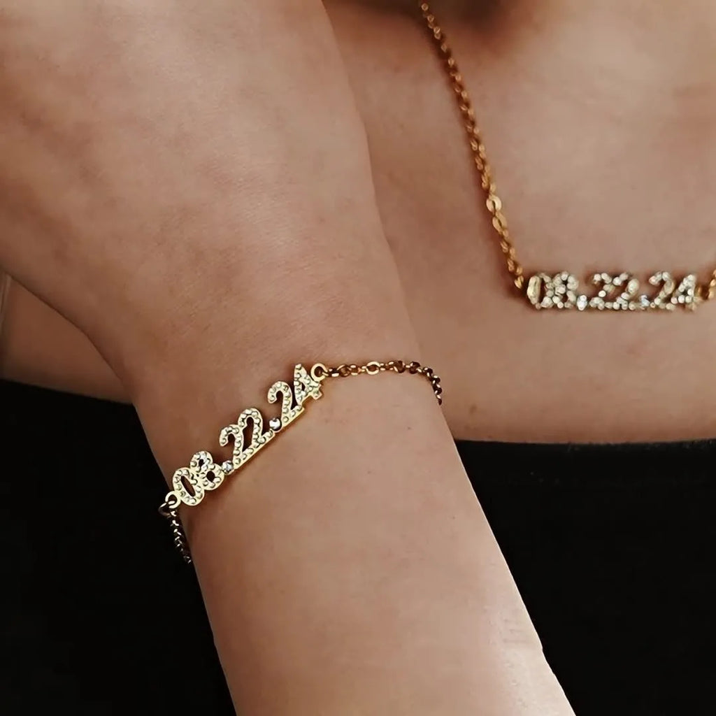 Stainless steel digital bracelet with crystal-set numbers on dial, shown in gold colour.