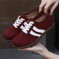 Women's vintage-style canvas sneakers with round toe and flat rubber sole in dark red.