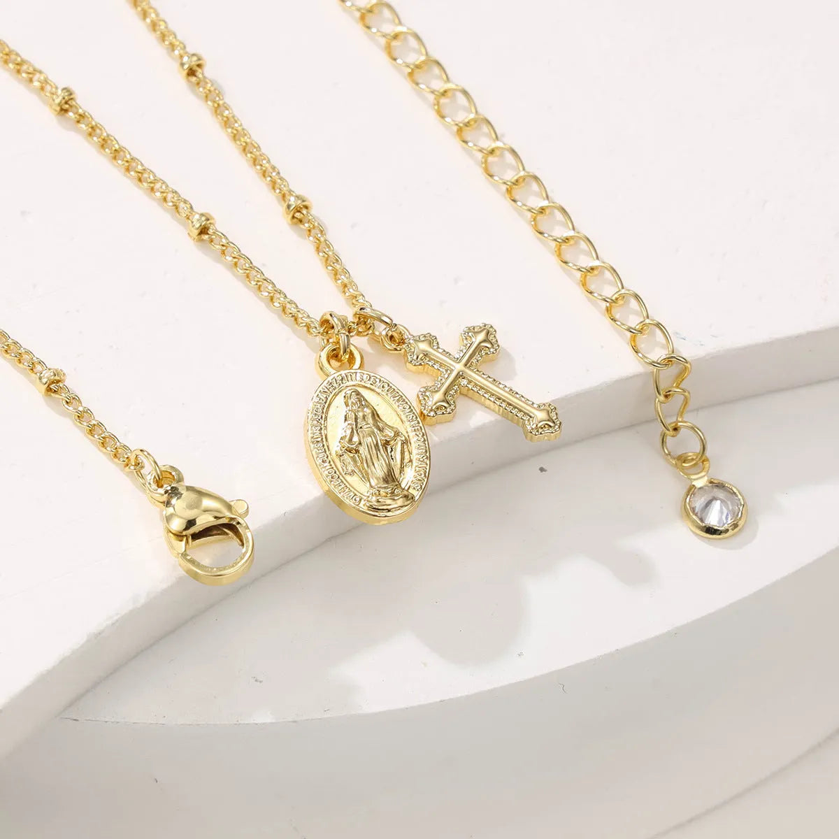 Gold Virgin Mary cross necklace with geometric pendant on 18K copper chain