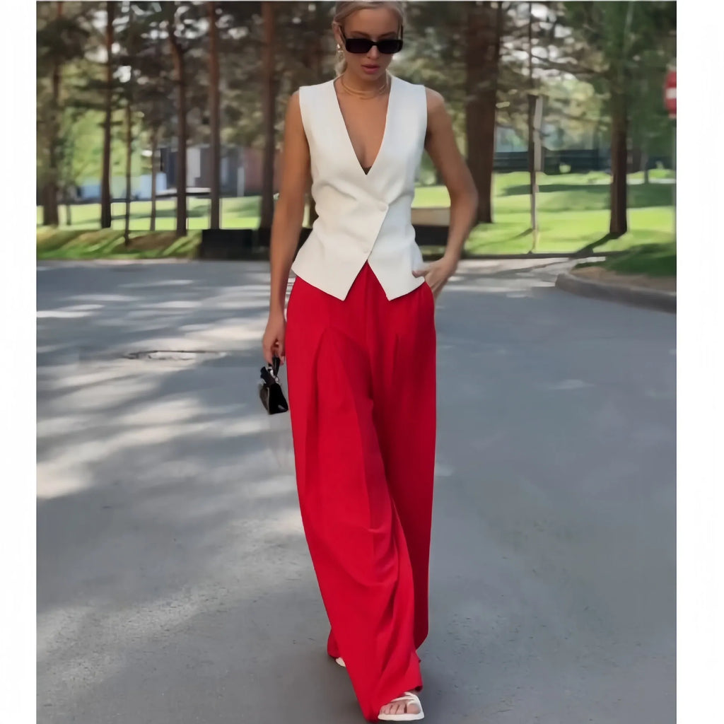 Beige women's two-piece set with deep V-neck sleeveless top and high-waist wide leg trousers