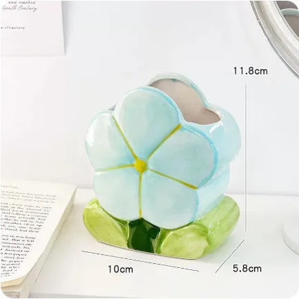 Ceramic flower pattern pen holder storage box on desk showing blue floral design