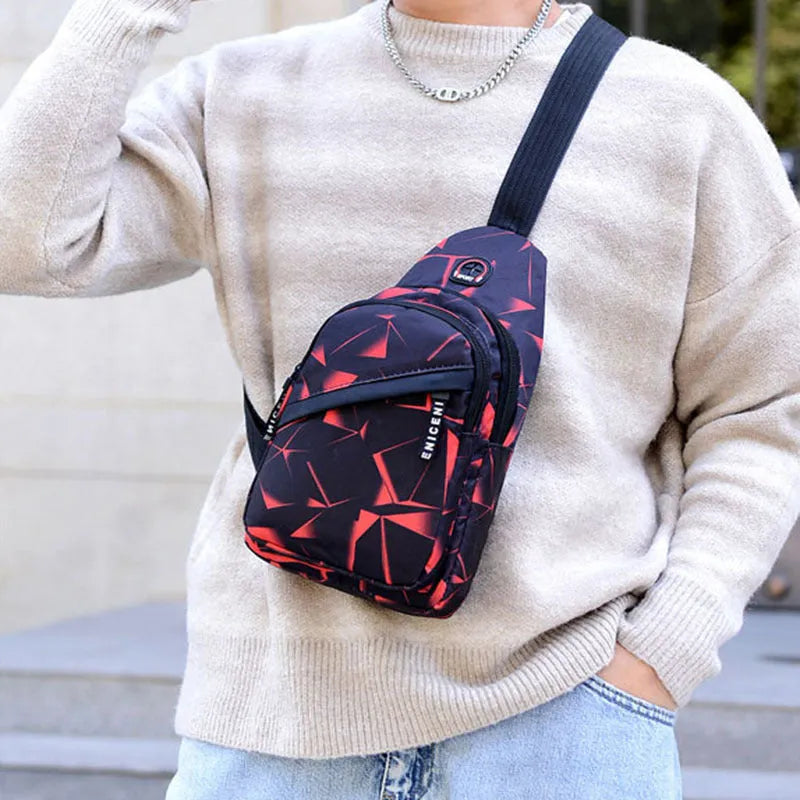 Men's blue Oxford cloth crossbody sling bag with earphone hole design showing zipper opening and letter print detail