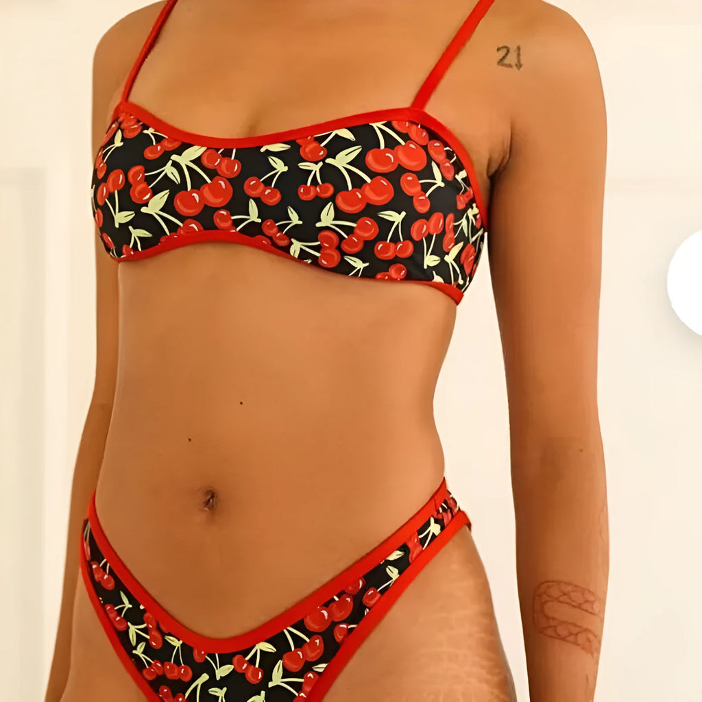 Women's cherry print tube top bikini swimsuit in brief style on a mannequin.