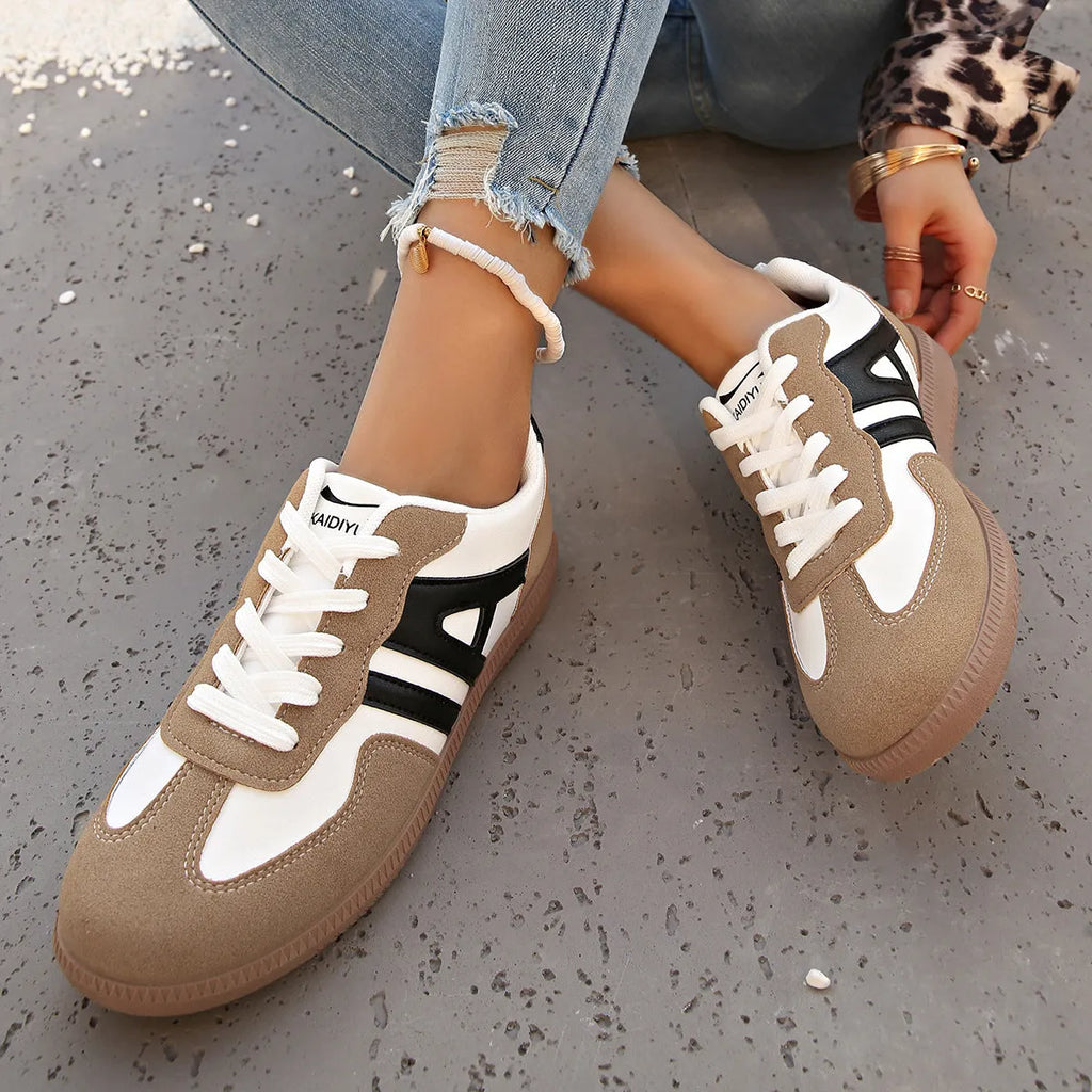 Retro women's jogging shoes in black with lace-up front, cross strap, and platform heel design