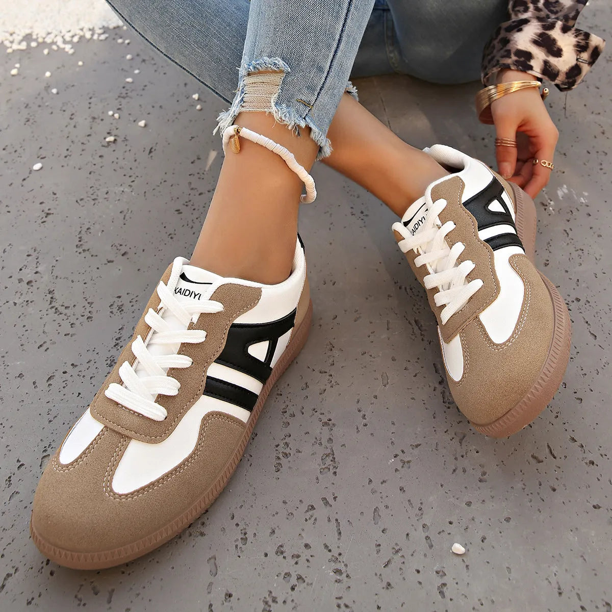 Retro women's jogging shoes in black with lace-up front, cross strap, and platform heel design