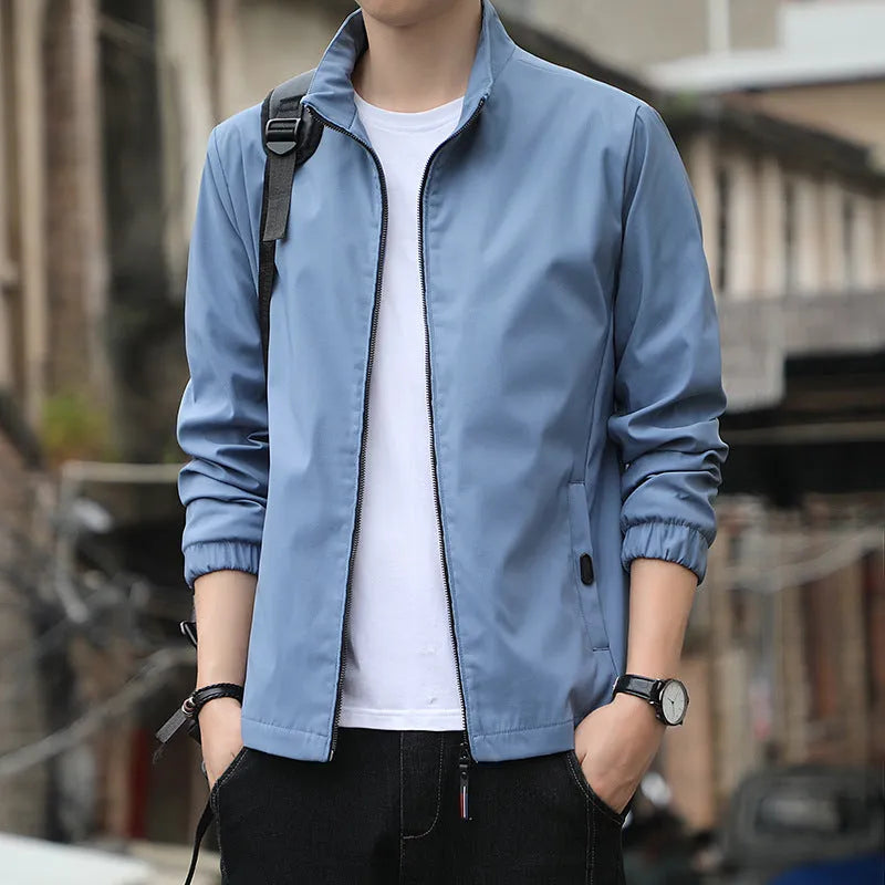 Man wearing a black Korean-style loose lapel casual jacket with zipper pockets.