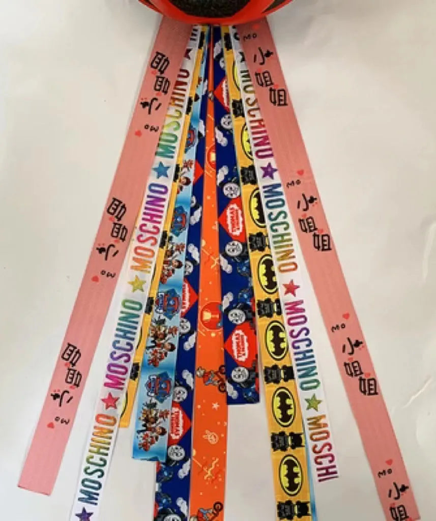 A colourful helmet streamer accessory for children's sports helmets and doll decoration.