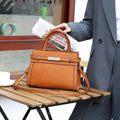 Small square genuine leather shoulder bag in neutral colour with internal organisation compartments