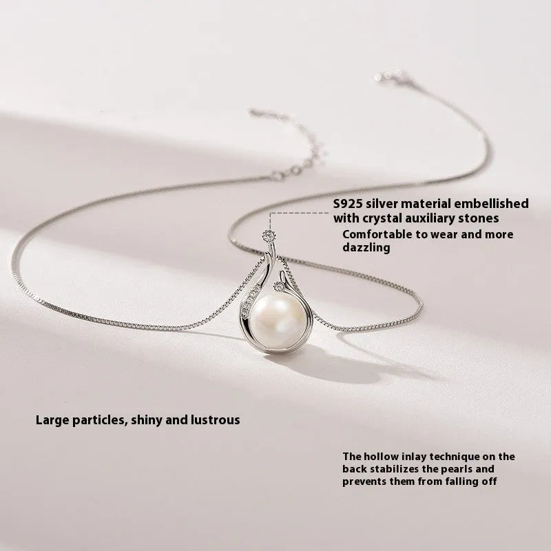 S925 silver necklace with natural freshwater pearl and geometric mother-of-pearl pendant on cross chain over a knitted sweater