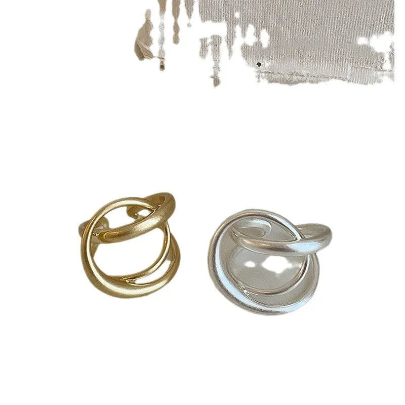 Geometric open ring with interlaced matte metal design in gold or silver electroplated finish