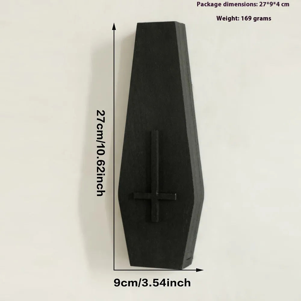 Black cross-shaped wooden wall shelf for home decoration, measuring 27 by 9 centimetres.