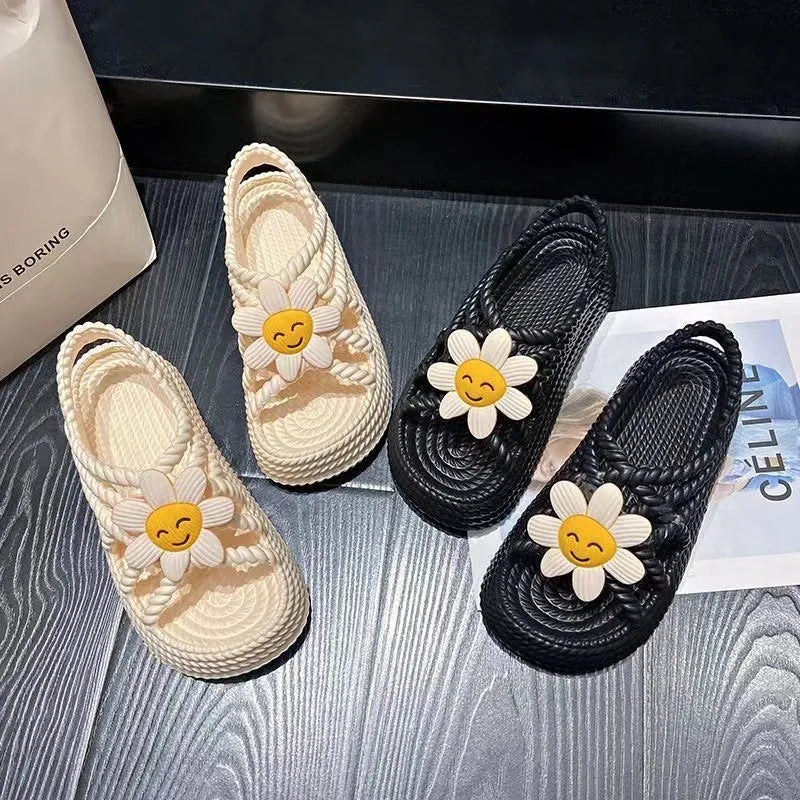 Beige PVC sandals with sunflower pattern and round toe on a non-slip sole.