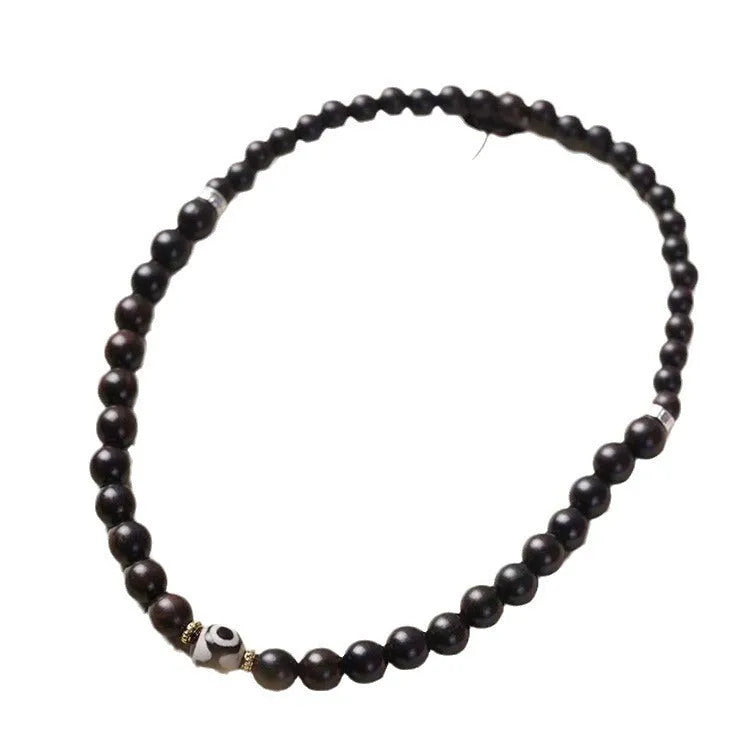 Solid ebony wood bracelet with 8mm Tibetan beads showing two-circle pattern