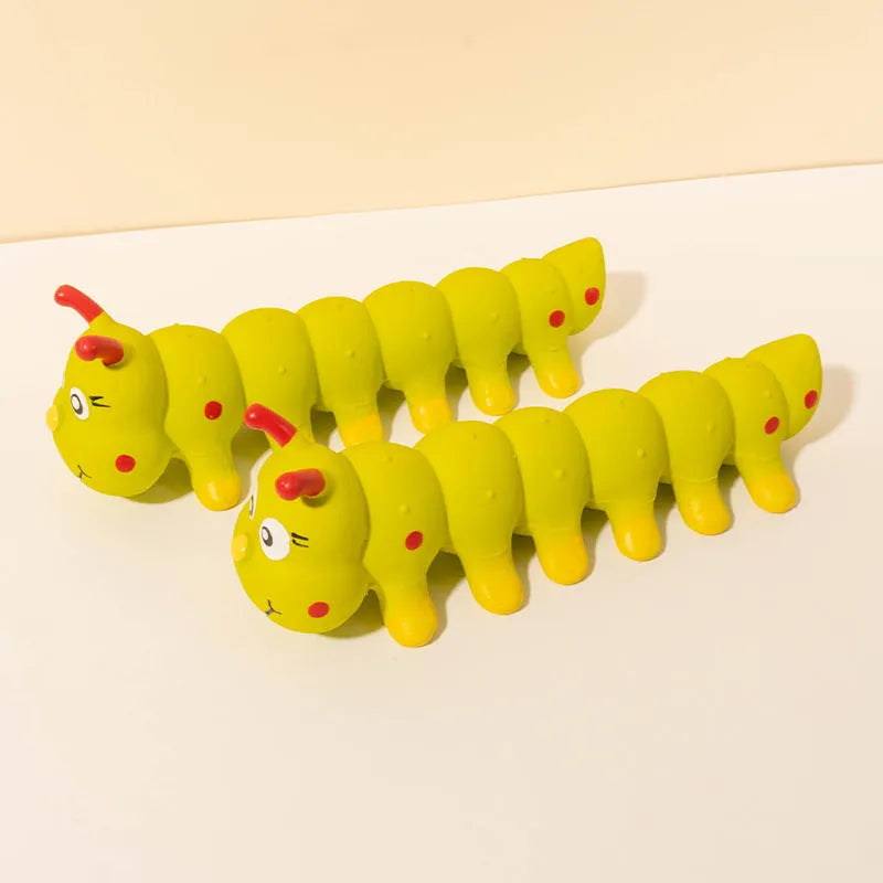 Yellow rubber caterpillar-shaped squeaky toy for dogs, shown next to a tape measure indicating 25.5cm length.
