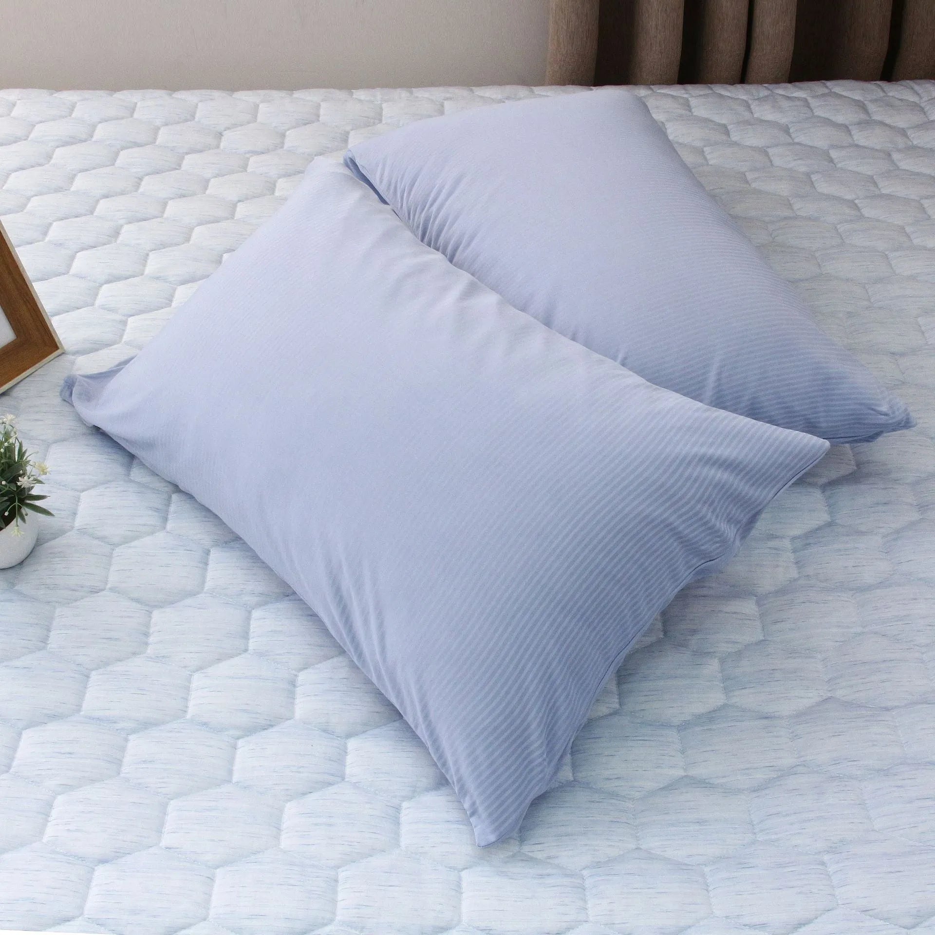 Blue and grey cooling blanket with Japanese Q-Max fibres on a bed.