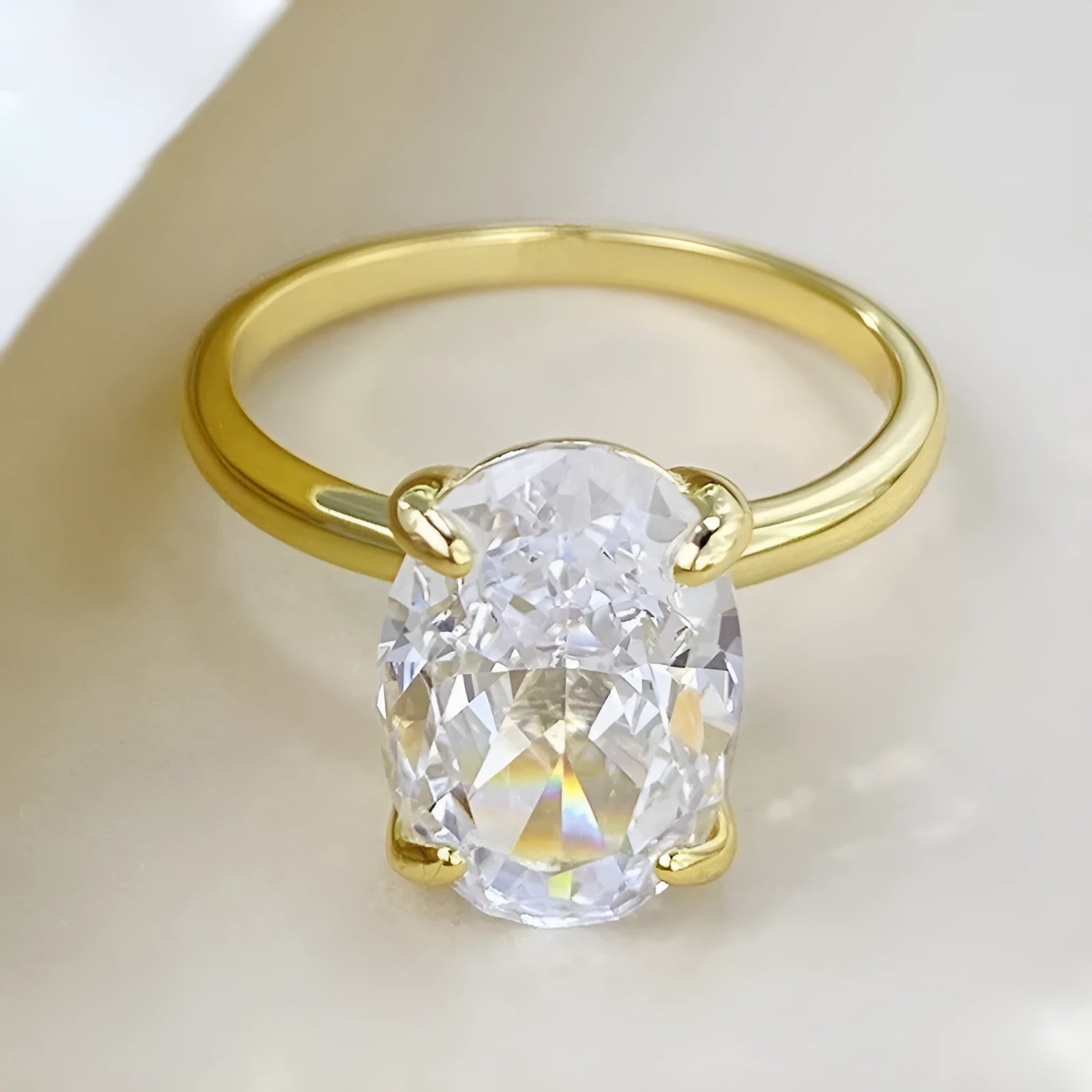 Oval women's silver ring with four-claw setting and cold luxury finish in gold or silver colours