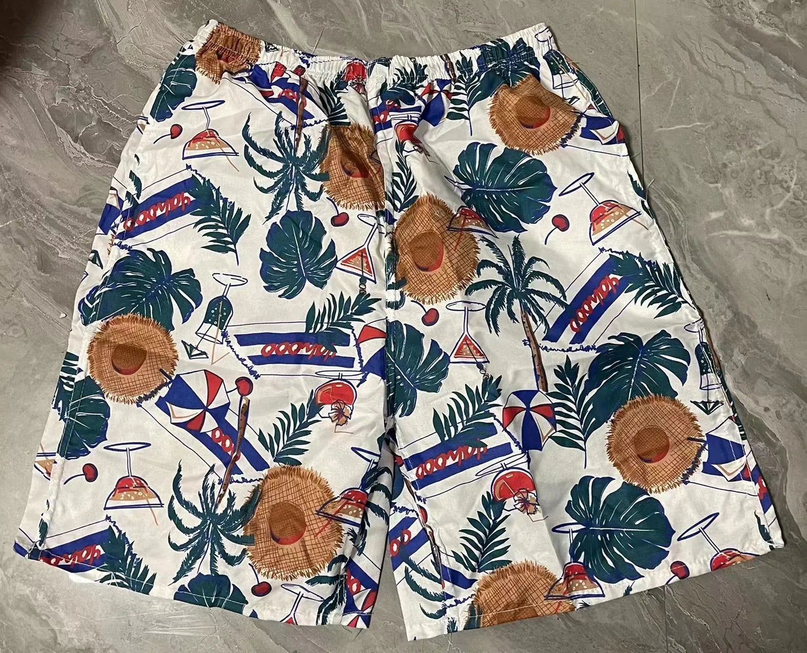 Men's casual floral print five-point swimming trunks made from polyester fabric.