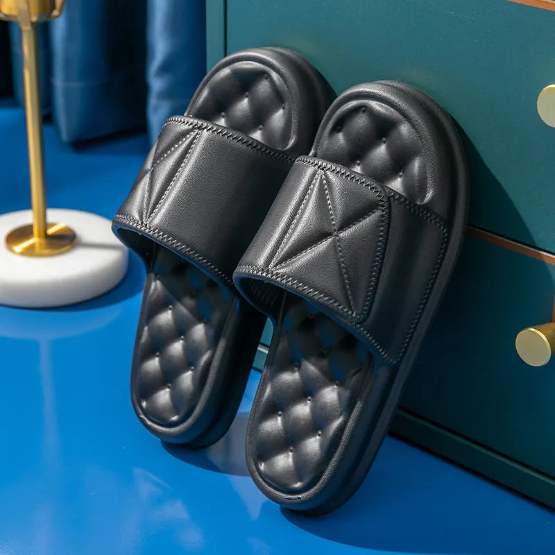 Pair of thick-soled EVA bathroom slippers in various colours, showing non-slip sole texture.