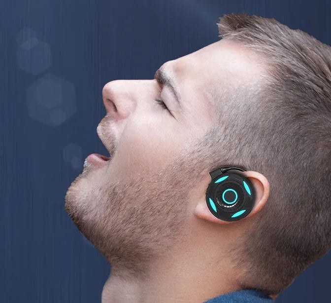 Black and white wireless Bluetooth earphones with hanging ear design and USB connectivity