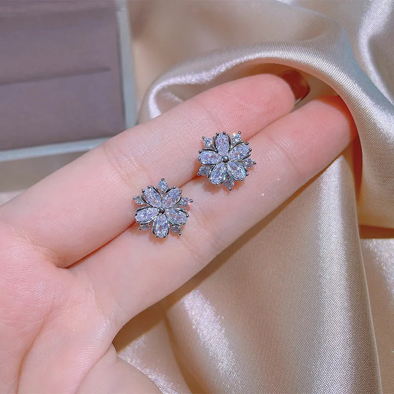 Double layer flower cubic zirconia ring necklace and stud earrings set in white copper on display