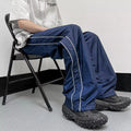 Men's navy blue wide leg striped casual pants made from lightweight polyester fabric, suitable for summer