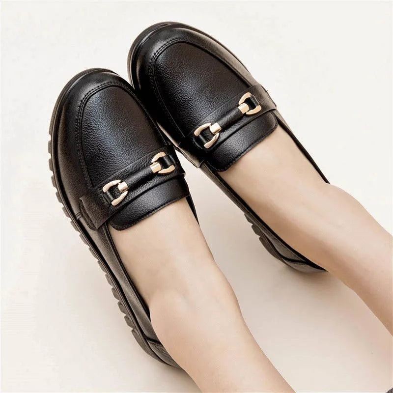Black soft leather women's pumps with round toe and low flat heel