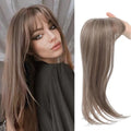 Synthetic high temperature fibre wig hairpiece with inner buckle and hair clip attachment in one of six colour styles.