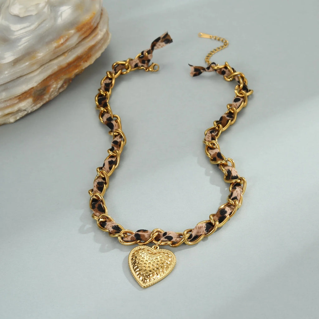 Gold-coloured stainless steel necklace with an adjustable chain and a choice of Big Heart or geometric Love Sun pendant.