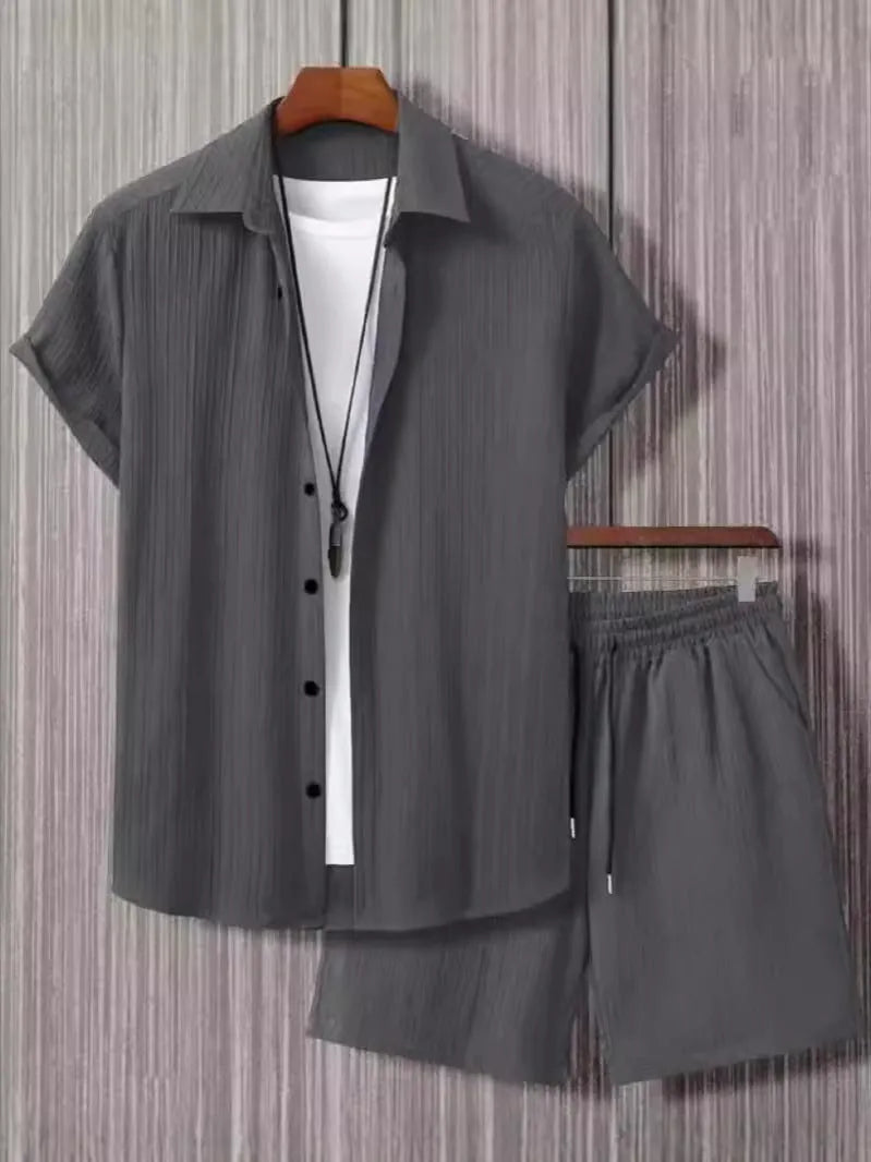 Man wearing a beige short sleeve jacquard suit shirt with matching shorts from a two-piece set.