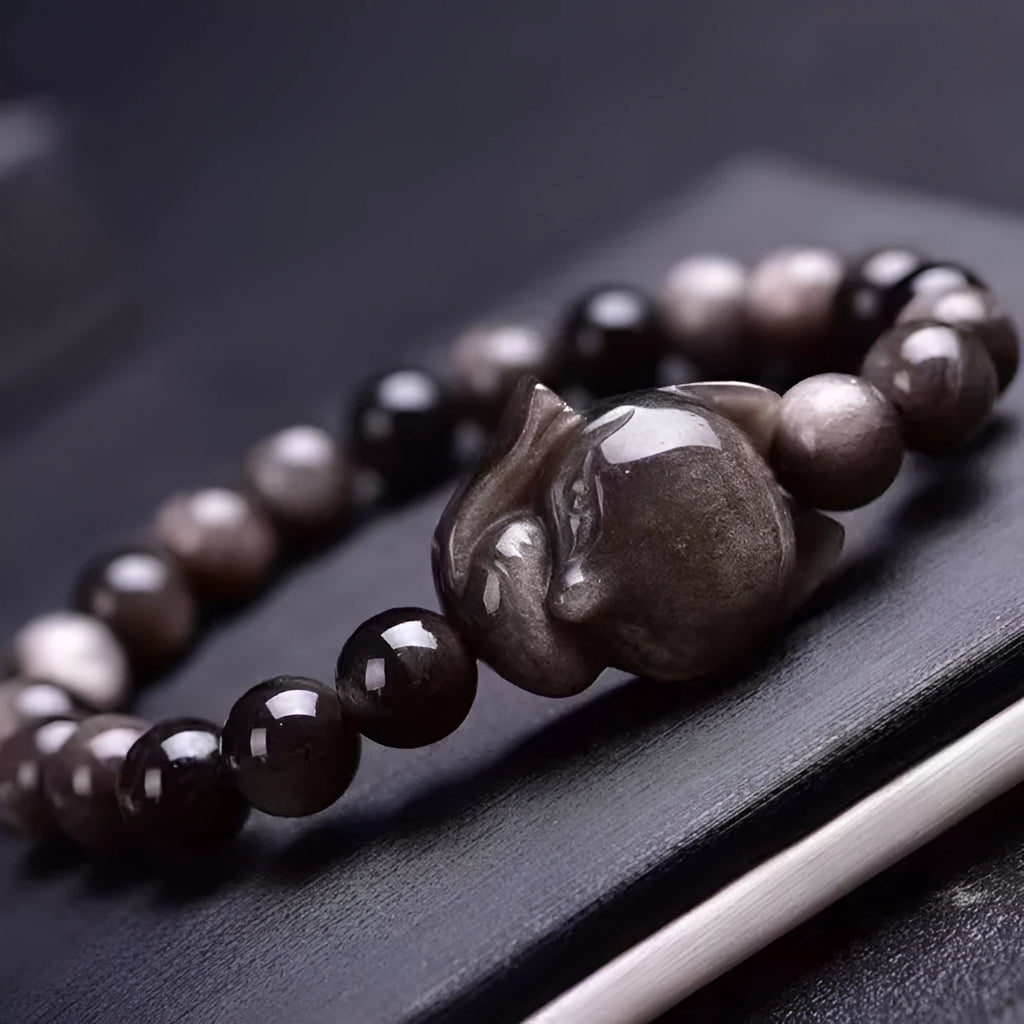 Obsidian fox bracelet with 8mm polished beads and silver fox charm on wrist