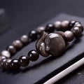 Obsidian fox bracelet with 8mm polished beads and silver fox charm on wrist