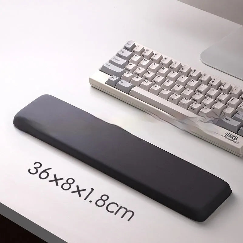 Square silicone wrist rest mouse pad with wrist strap in multiple colour options on a desk