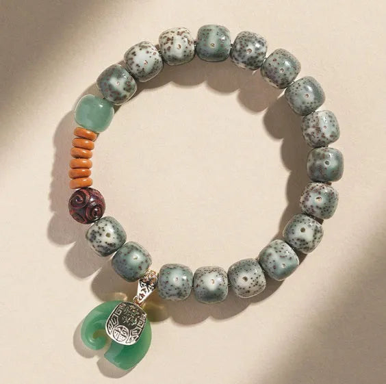 Jade green star moon bodhi bracelet with 10mm geometric beads on white background