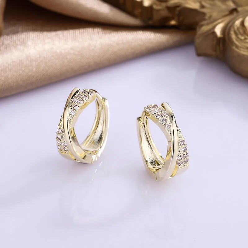 Geometric earrings with copper construction and 14K yellow finish featuring zircon sparkle treatment