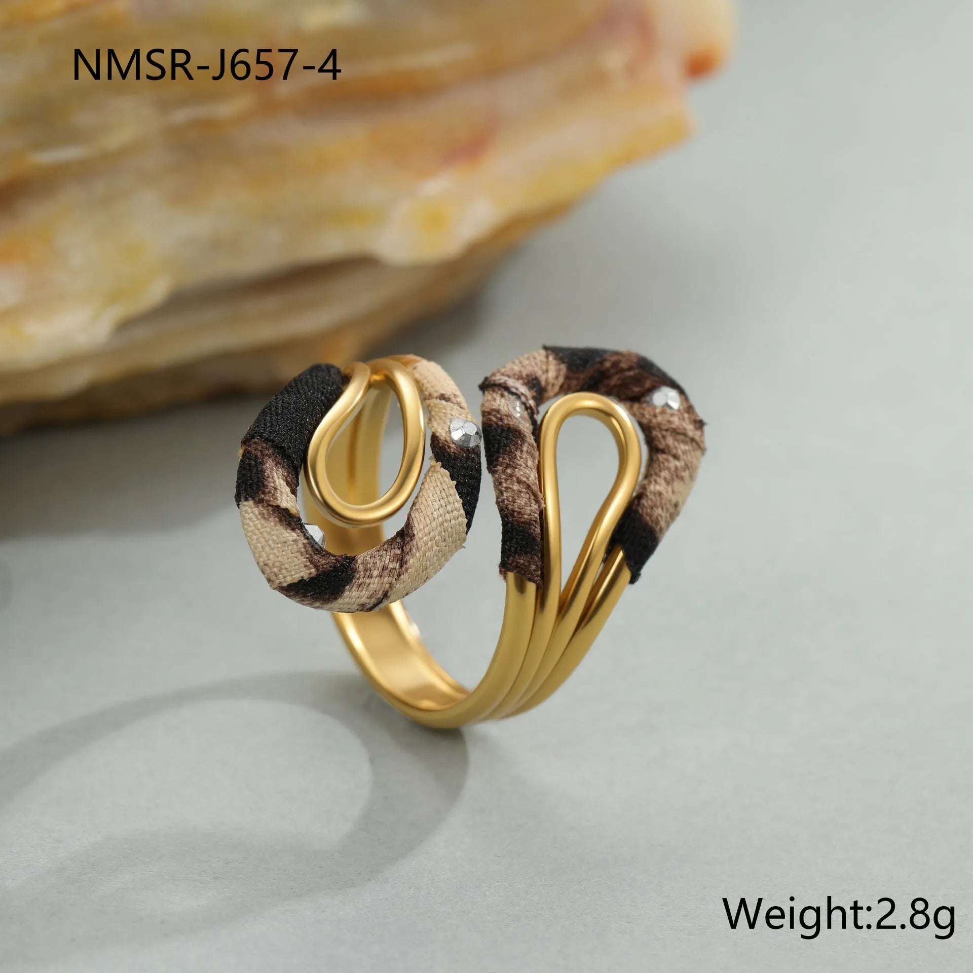Stainless steel open mouth ring with leopard print in geometric shape on a hand.