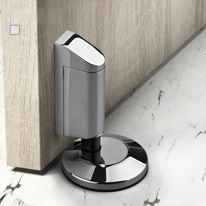Zinc alloy invisible door stopper in brushed nickel finish on a wooden floor