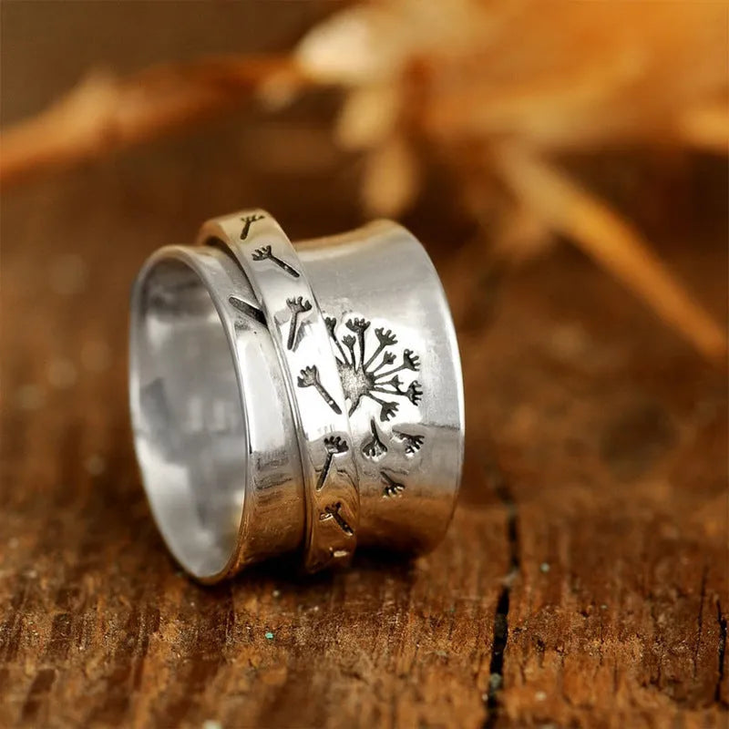 Silver colour rotatable flower ring on finger showing floral centrepiece